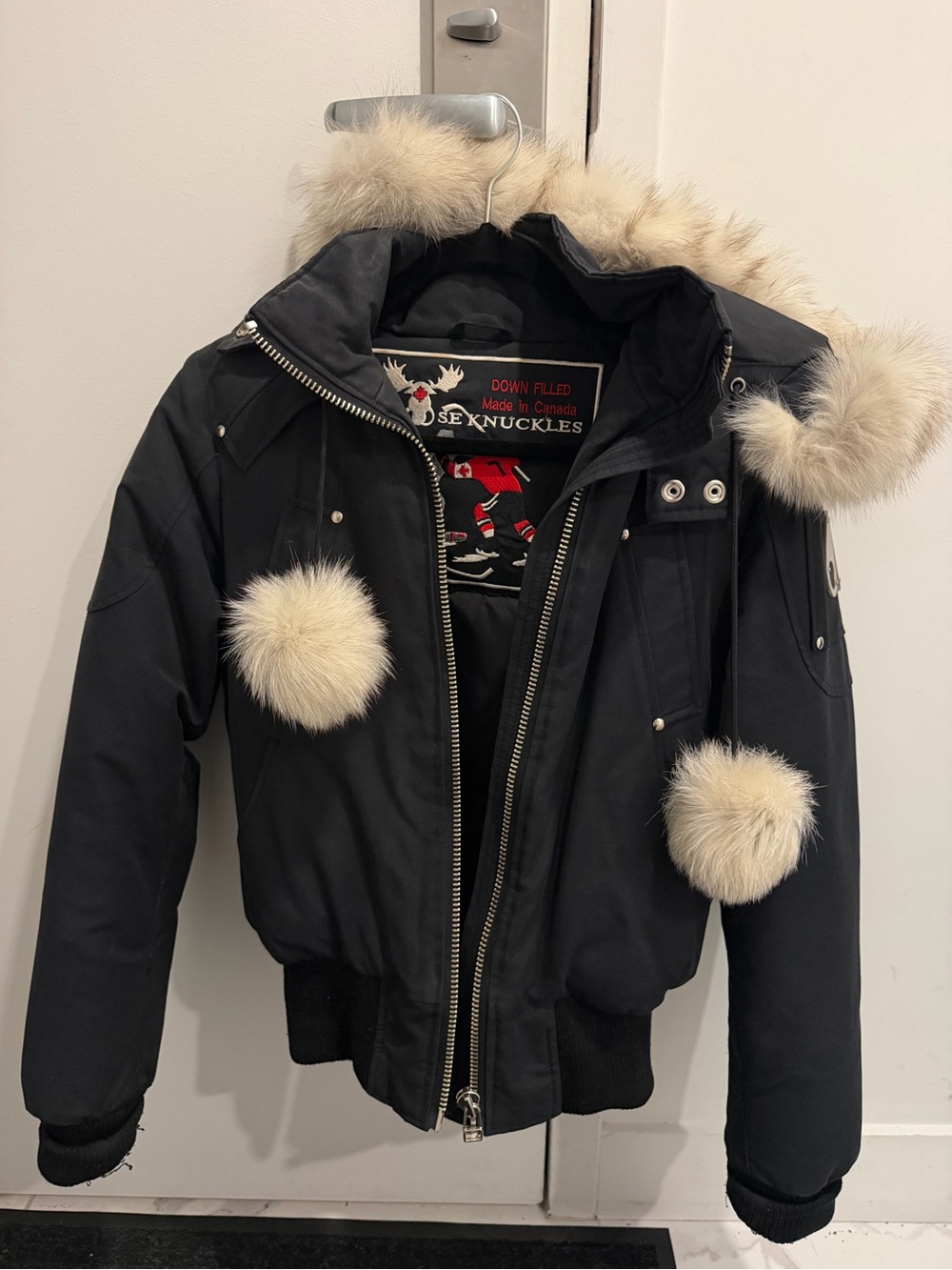 Moose Knuckles Black Puffer Jacket with Cream Fur Trim and Pom-Poms